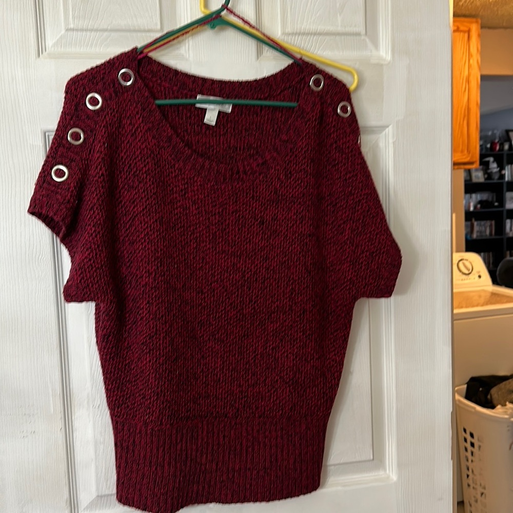 Cranberry colored short sleeve crew neck with with grommet detail on shoulders